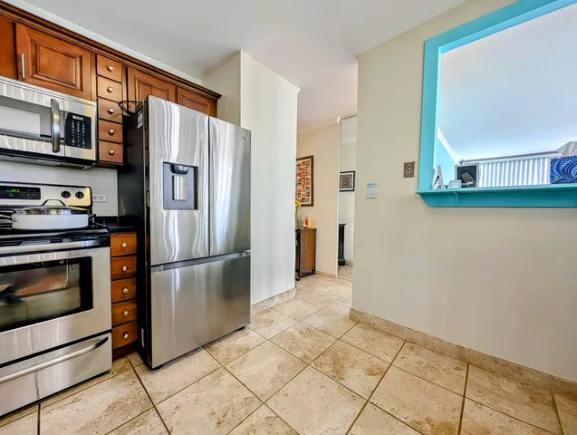 a kitchen with stainless steel appliances a refrigerator and a stove top oven