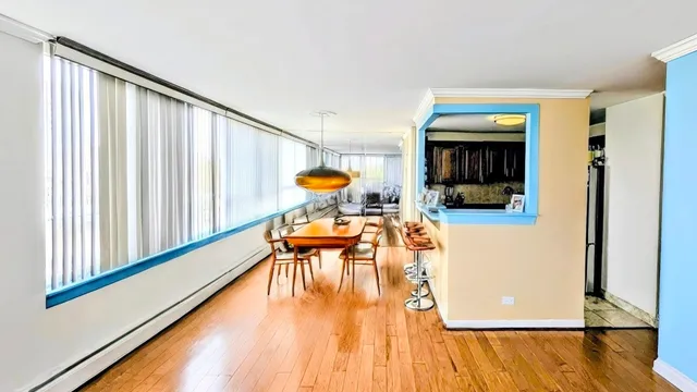a dining room with furniture and wooden floor