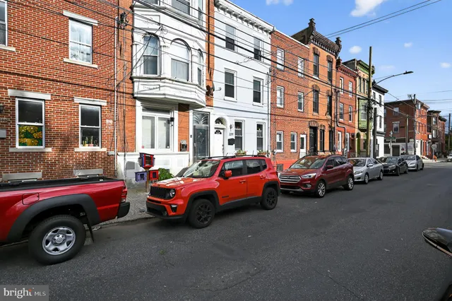 a couple of cars parked in front of a building
