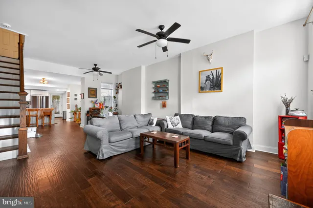 a living room with furniture or couch and a ceiling fan