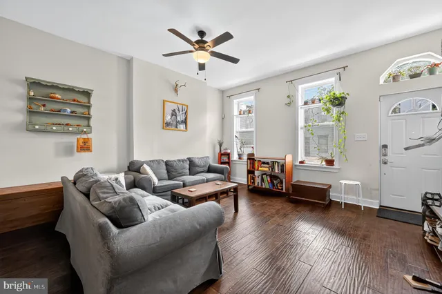 a living room with furniture and wooden floor