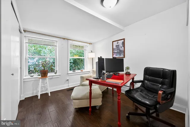 a living room with furniture a flat screen tv and a window