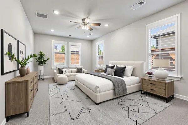 a spacious bedroom with a bed and a chandelier