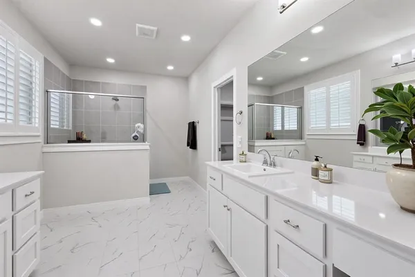 a bathroom with a sink double vanity and a mirror