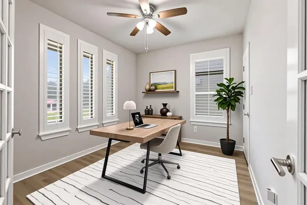 a view of a workspace with furniture and a window