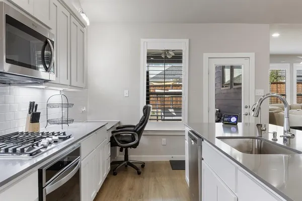 a kitchen with a stove and a sink