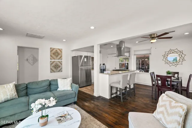 a living room with furniture and wooden floor