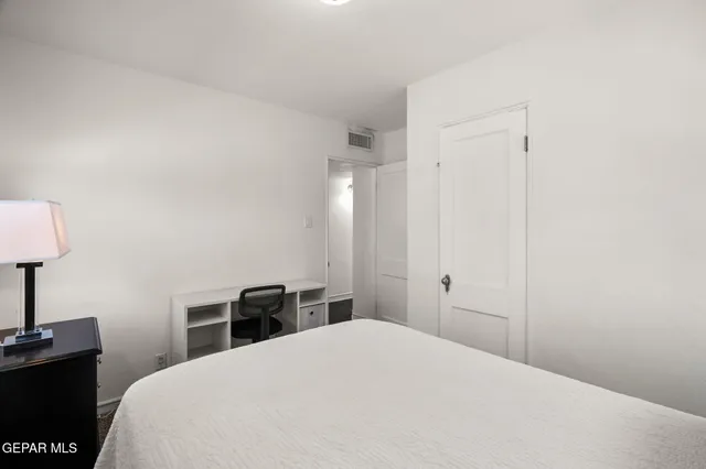 a bedroom with a bed and a table