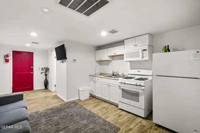 a kitchen with stainless steel appliances a refrigerator sink stove and refrigerator