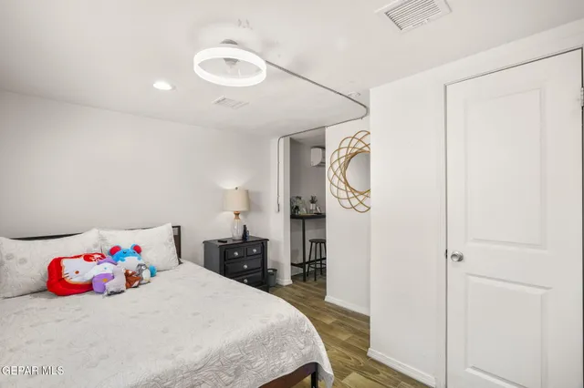 a bedroom with a bed and a dresser