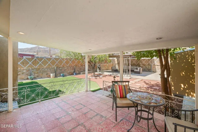 a view of a chairs and table in the patio