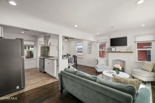 a living room with furniture a fireplace and a flat screen tv