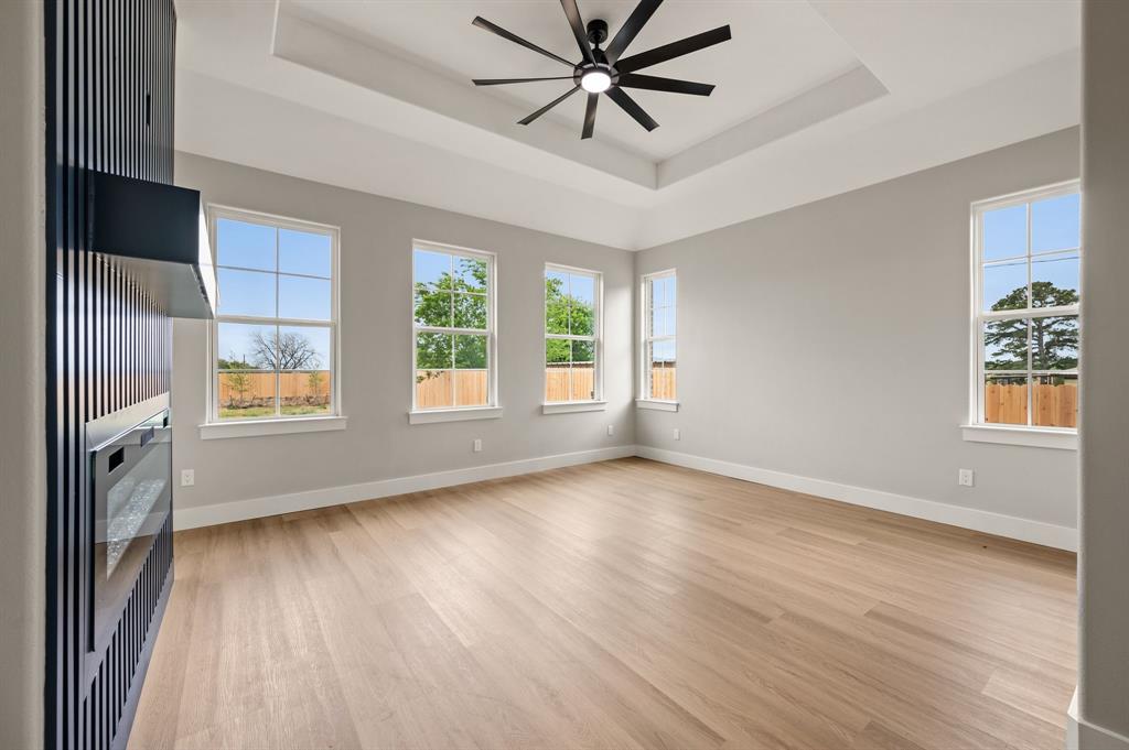 806 N Avenue East Springtown, TX 76082 - Photo 13 of 25 a view of an empty room with a window and wooden floor