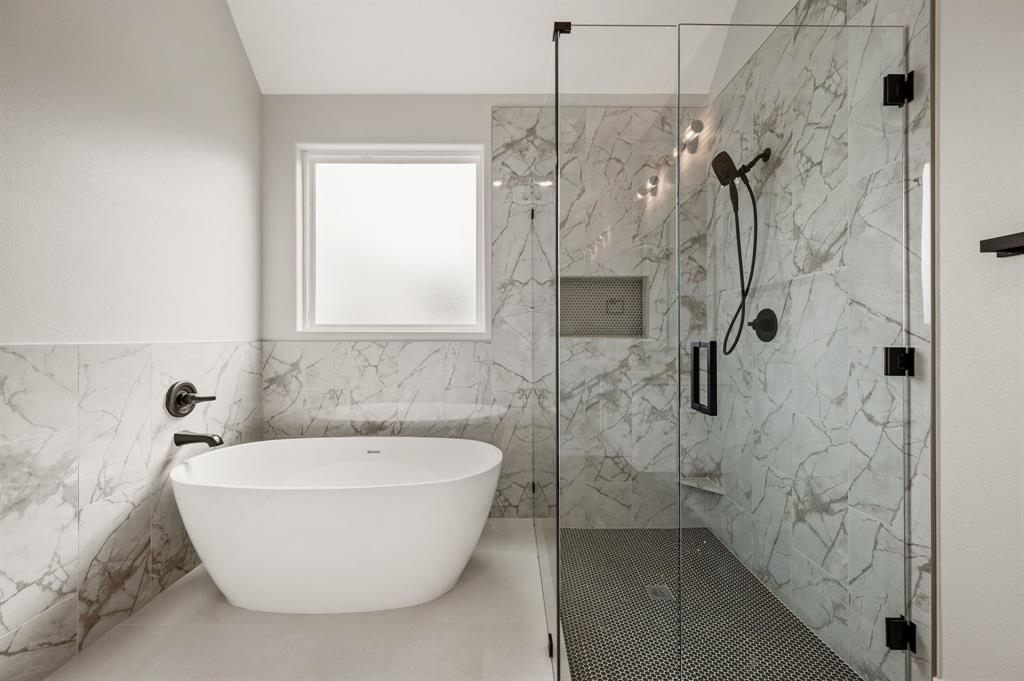 806 N Avenue East Springtown, TX 76082 - Photo 15 of 25 a white bath tub sitting in a bathroom and a shower