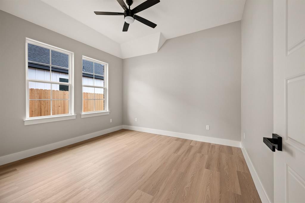 806 N Avenue East Springtown, TX 76082 - Photo 20 of 25 a view of a room with a wooden floor and windows