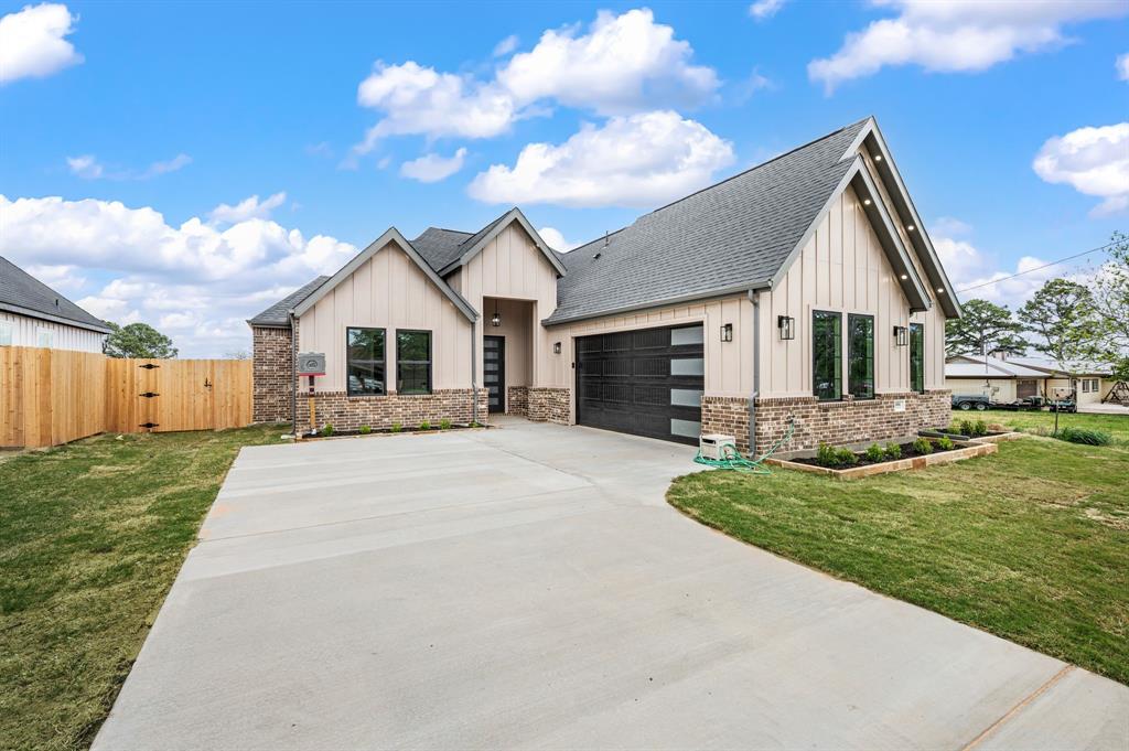 806 N Avenue East Springtown, TX 76082 - Photo 2 of 25 a front view of a house with a yard and garage