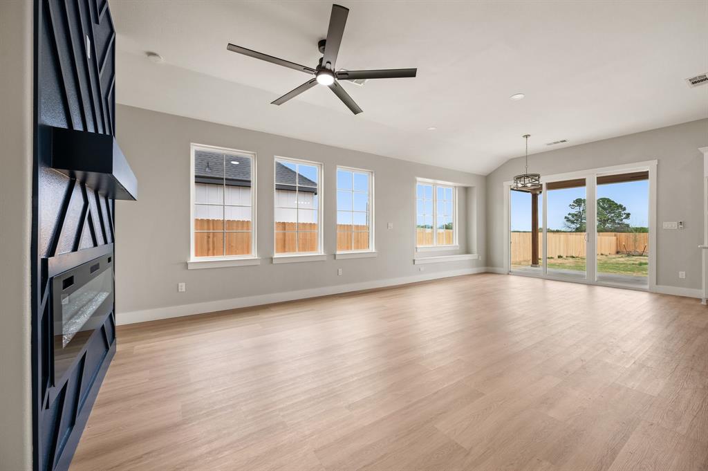 806 N Avenue East Springtown, TX 76082 - Photo 3 of 25 a view of an empty room with a window and wooden floor