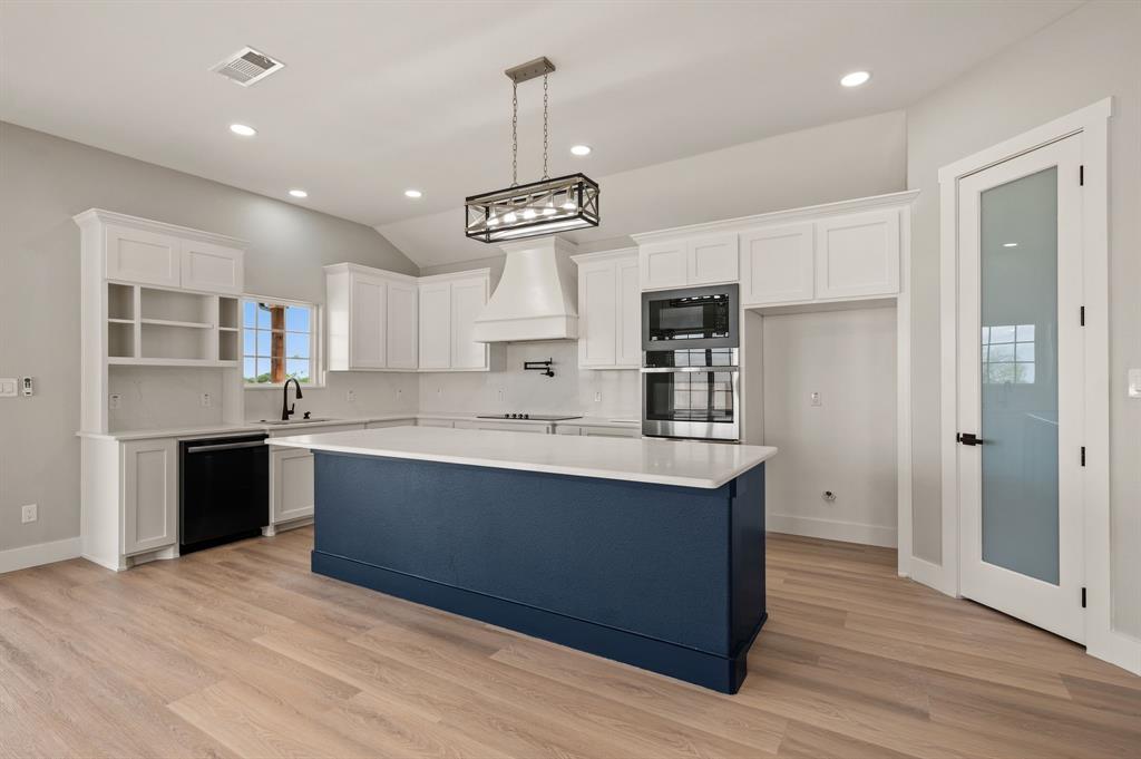 806 N Avenue East Springtown, TX 76082 - Photo 8 of 25 a large kitchen with stainless steel appliances granite countertop a sink refrigerator and cabinets