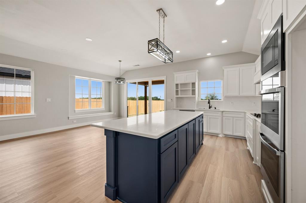 806 N Avenue East Springtown, TX 76082 - Photo 9 of 25 a kitchen with counter top space a sink appliances and cabinets
