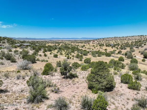a view of a large building with mountains in the background