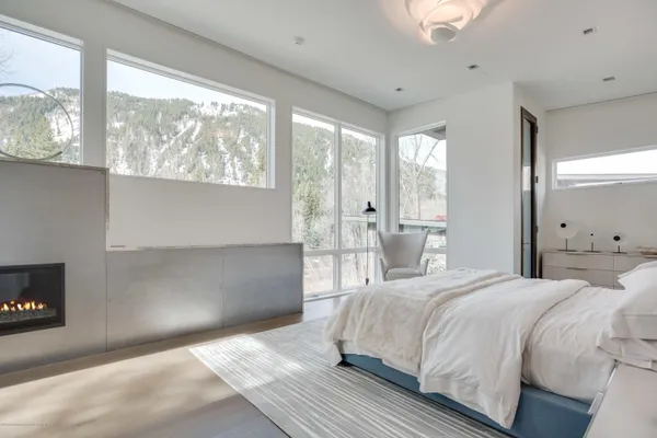 a bedroom with a large bed and a large window