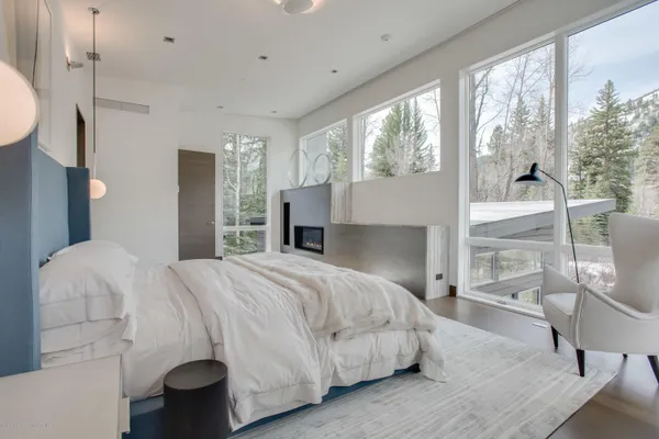 a bedroom with a bed and glass window