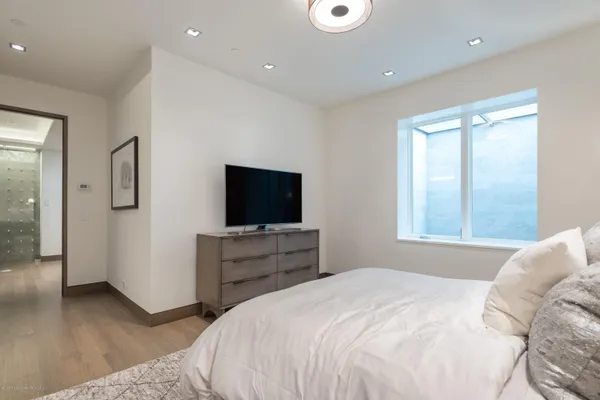 a bedroom with a bed and a flat screen tv