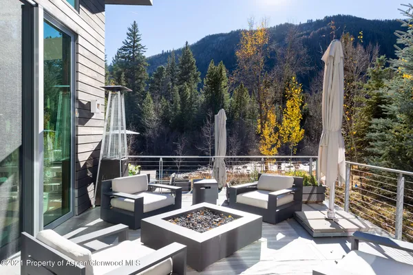 a view of a chairs and table in patio