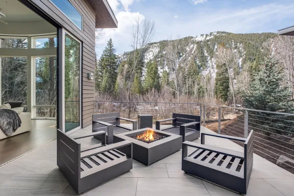 a view of a patio with couches and a table and chairs with wooden floor
