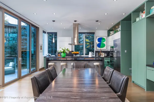 a living room with furniture large window and wooden floor