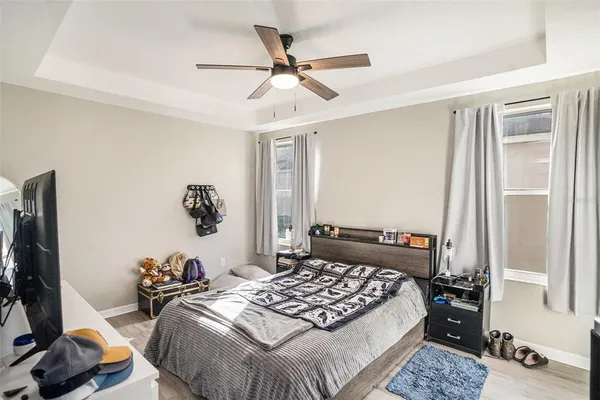 a bedroom with a bed and a flat tv screen