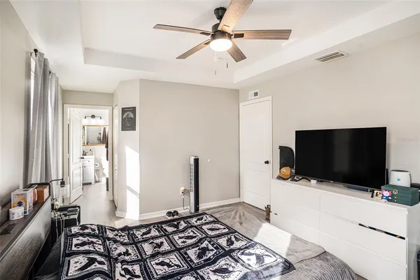 a bedroom with a bed and a flat screen tv