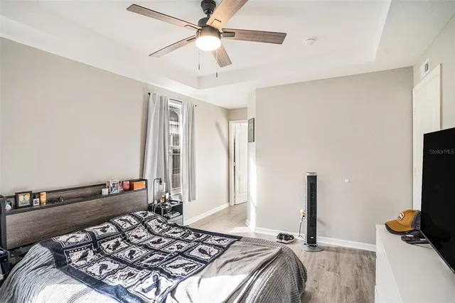 a bedroom with a bed and a flat screen tv