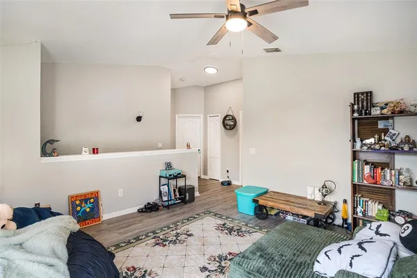 a bedroom with furniture and a book shelf