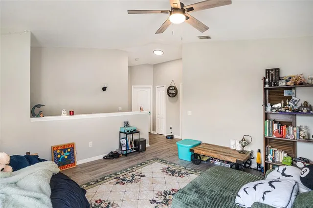 a bedroom with furniture and a book shelf