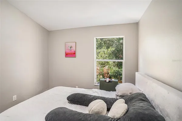 a bedroom with a bed and a window