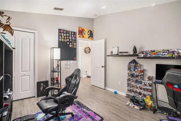 a view of a workspace with furniture and wooden floor