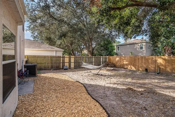 a view of a backyard with a large tree
