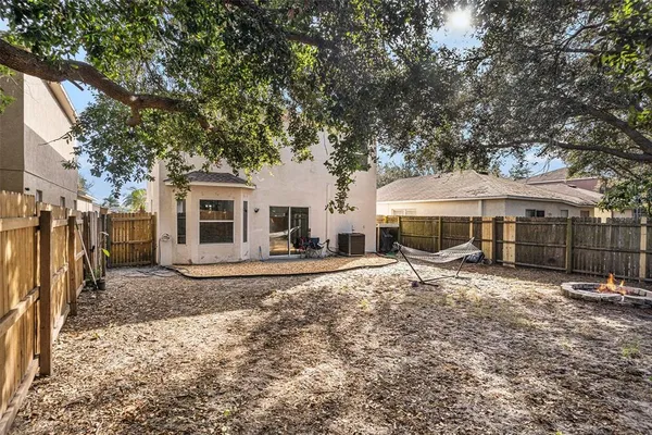 a white house covered with tall trees