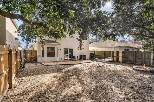 a white house covered with tall trees