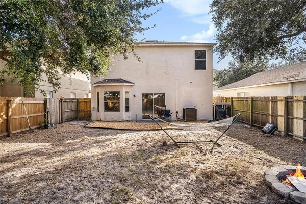 a white house that has a tree in front of it