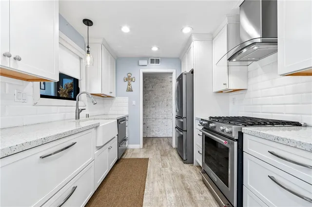 a stove top oven sitting inside of a kitchen