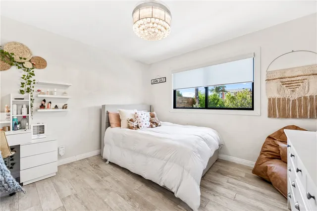 a bedroom with furniture and a chandelier fan
