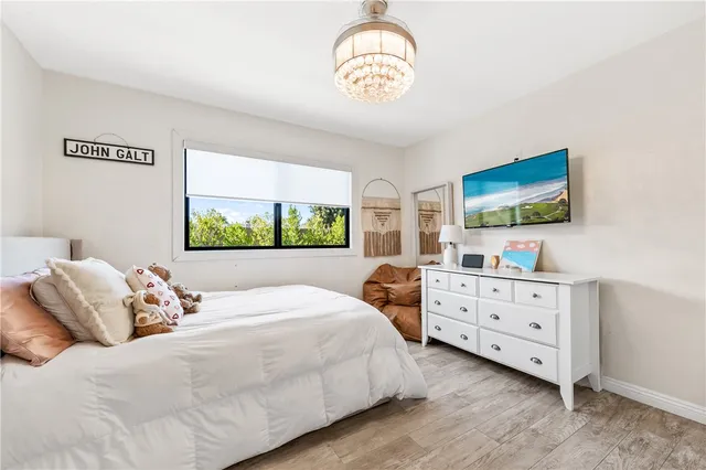 a bedroom with a bed and a chandelier