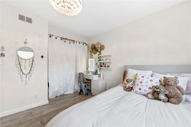 a bedroom with a bed and a chandelier