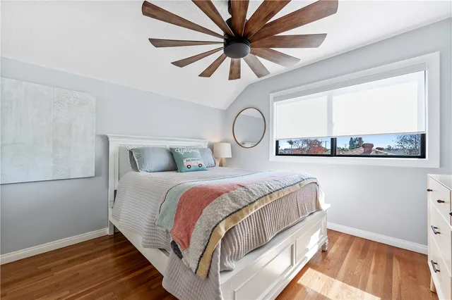 a bathroom with a granite countertop sink mirror vanity and toilet