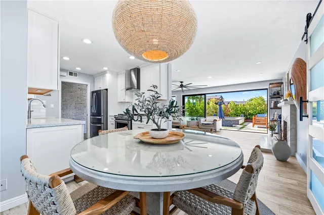 a kitchen with a sink and chairs