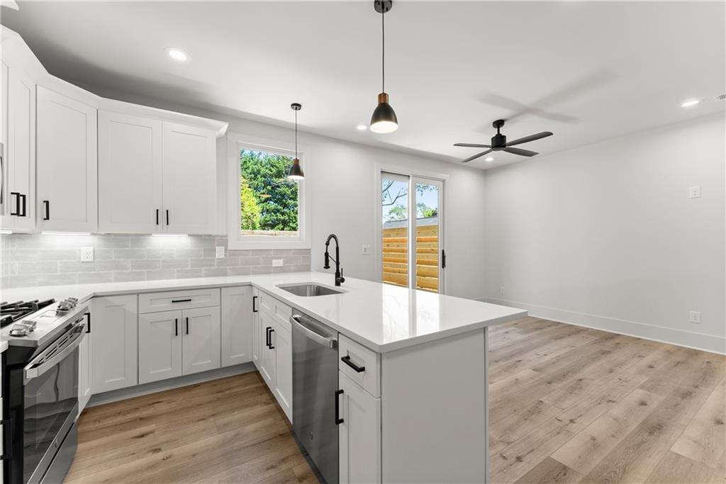 380 Forrest Avenue Gainesville, GA 30501 - Photo 11 of 31 a kitchen with sink cabinets and window