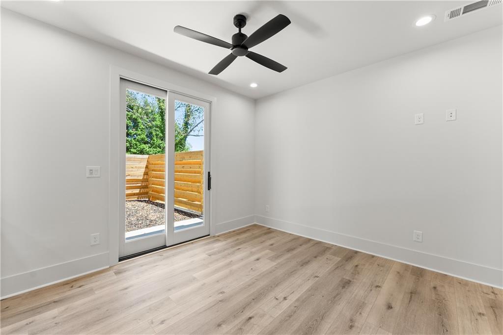 380 Forrest Avenue Gainesville, GA 30501 - Photo 17 of 31 an empty room with wooden floor and windows