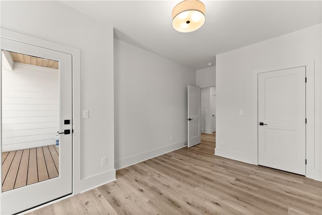 380 Forrest Avenue Gainesville, GA 30501 - Photo 29 of 31 a view of an empty room with wooden floor and a window